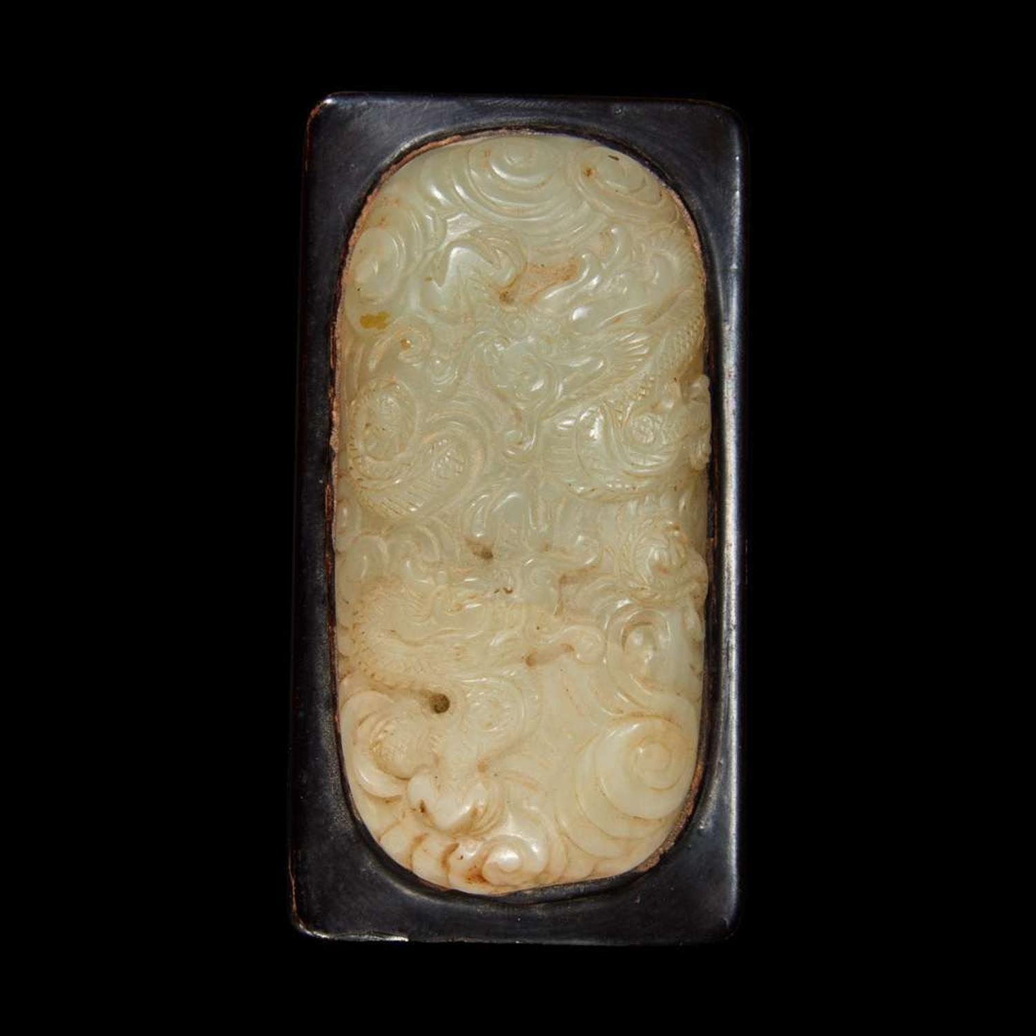 A Chinese celadon jade libation cup, Yi, and a carved grey-white jade oval "Dragon" plaque the jades late Ming to Qing Dynasty