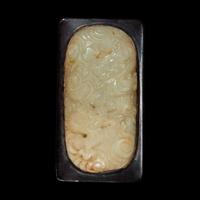 A Chinese celadon jade libation cup, Yi, and a carved grey-white jade oval "Dragon" plaque the jades late Ming to Qing Dynasty