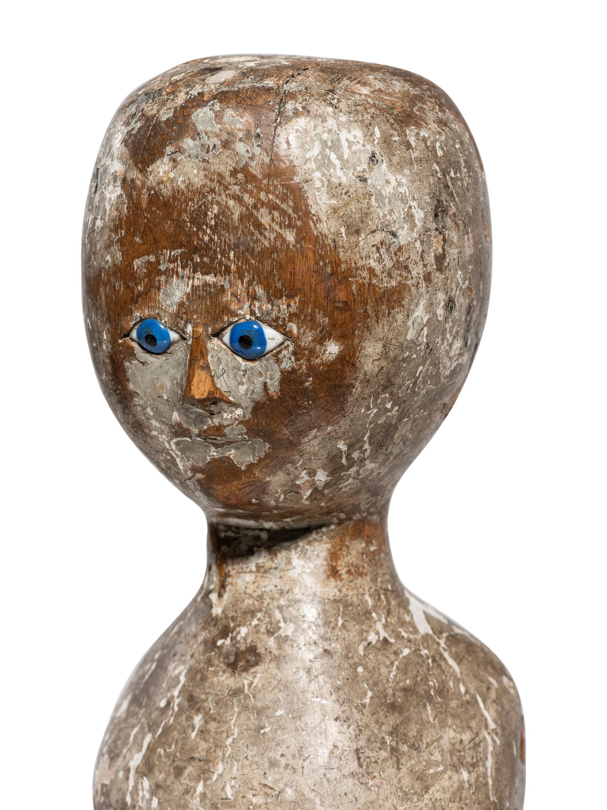 A Folk Art Carved, Painted and Glass Inset Wood Doll "Bed Post" Figure