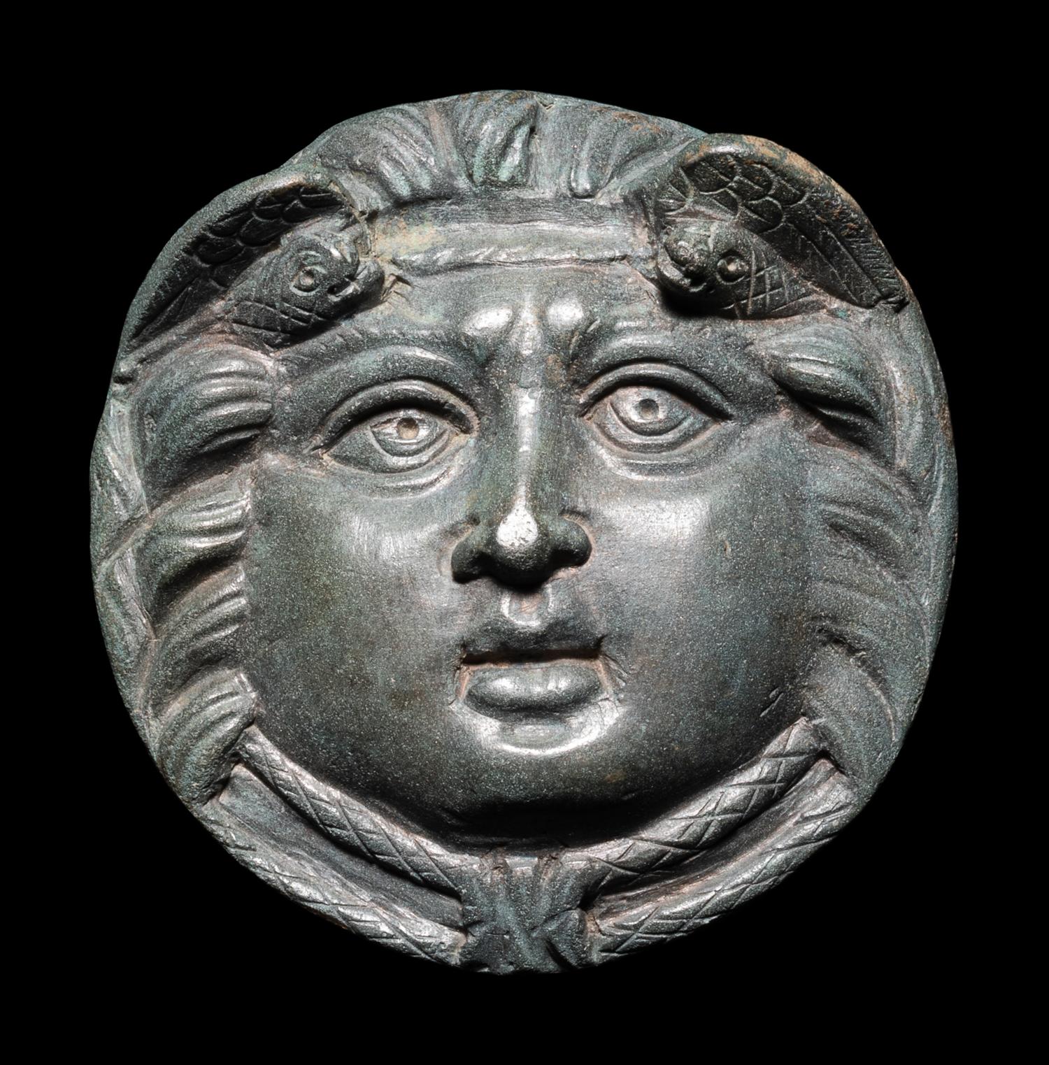 A Roman Bronze Roundel with Head of a Gorgon