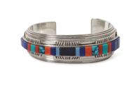 A Kiowa Silver, Lapis, Coral, Silica, and Turquoise Bracelet, Byron McCurtain Length 5 1/2 x opening 1 1/8 x width 3/4 inches.