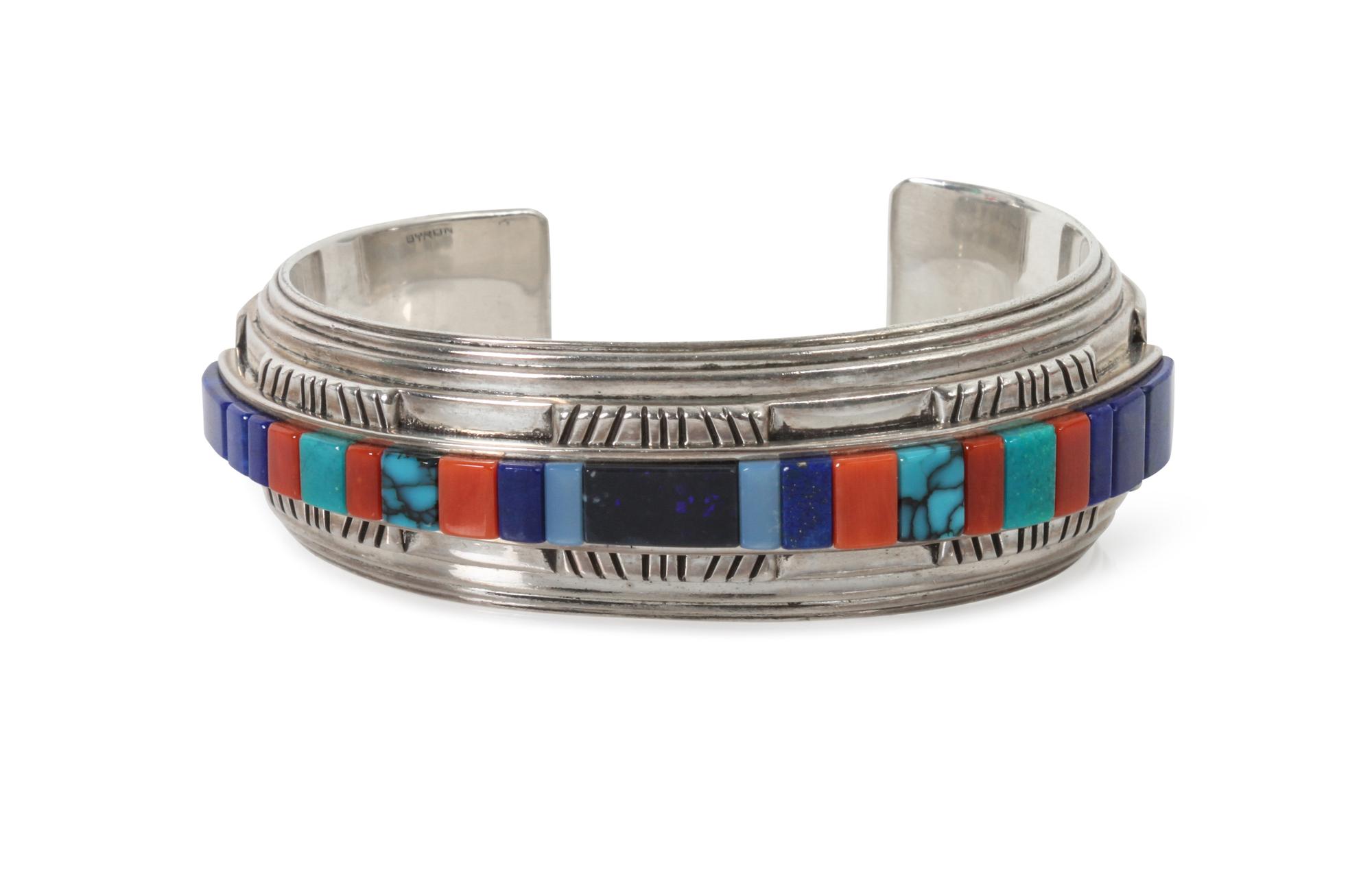 A Kiowa Silver, Lapis, Coral, Silica, and Turquoise Bracelet, Byron McCurtain Length 5 1/2 x opening 1 1/8 x width 3/4 inches.