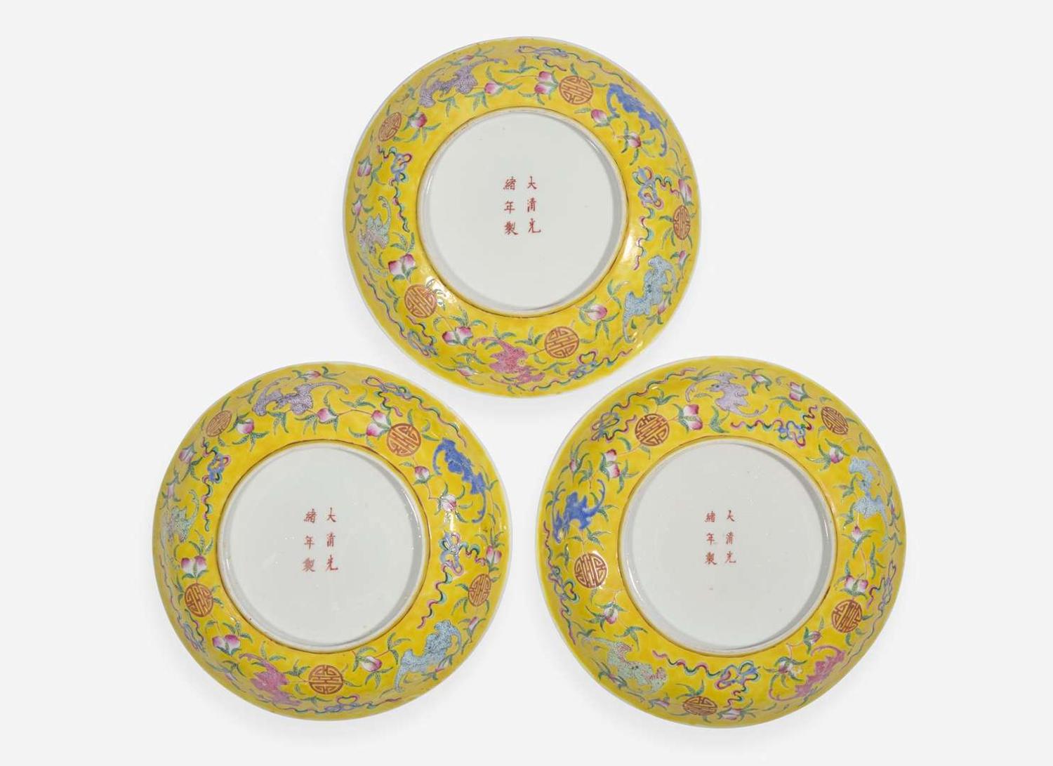 A group of three Chinese yellow-ground dishes, Guangxu marks and probably of the period 五蝙黃地盤一組三件 光緒款 或清光緒