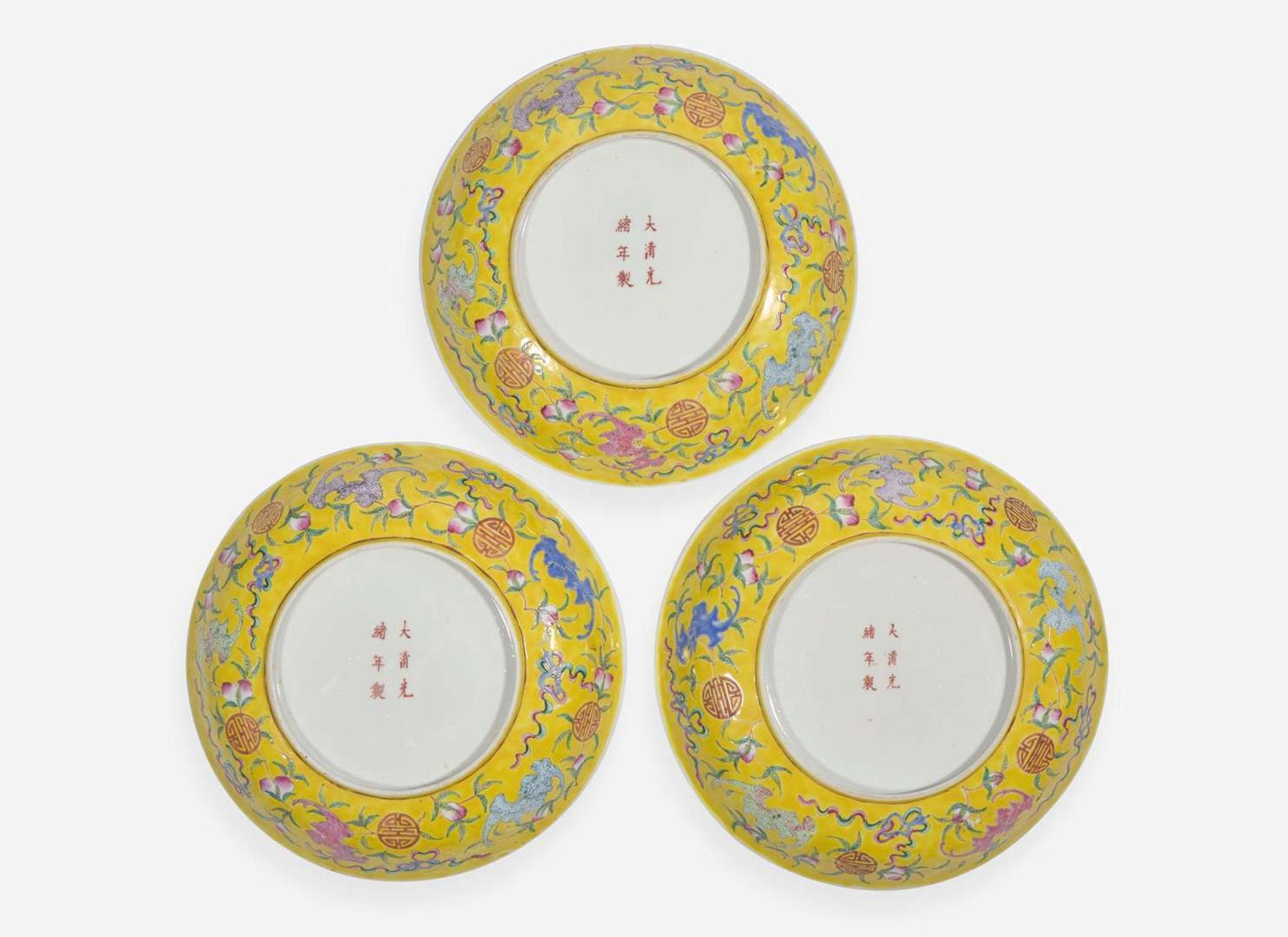 A group of three Chinese yellow-ground dishes, Guangxu marks and probably of the period 五蝙黃地盤一組三件 光緒款 或清光緒