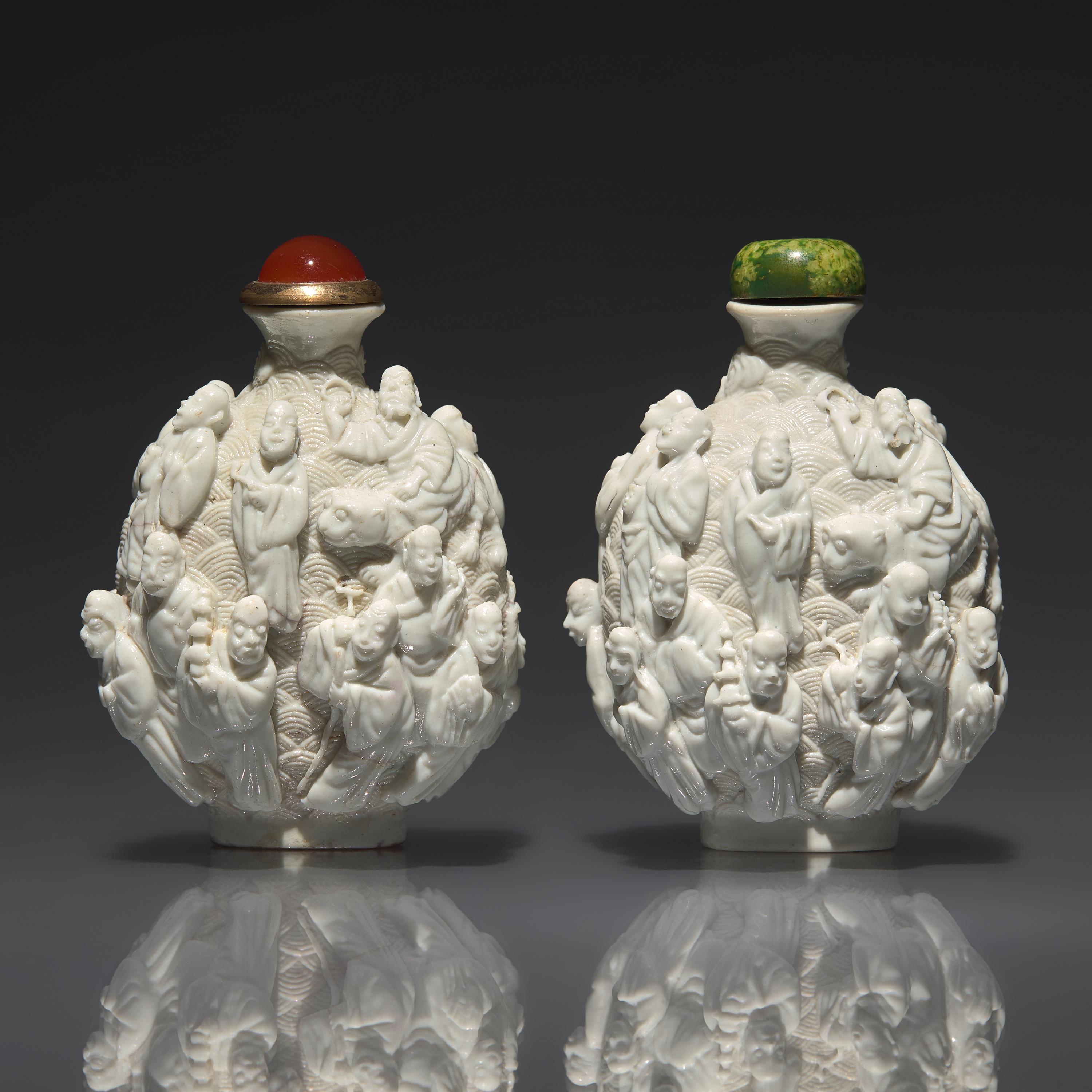 An Assembled Pair of Molded Porcelain "Lohan" Snuff Bottles, Qing Dynasty, Jiaqing Period — 清嘉慶 白釉瓷胎模製十八羅漢鼻煙壺兩支