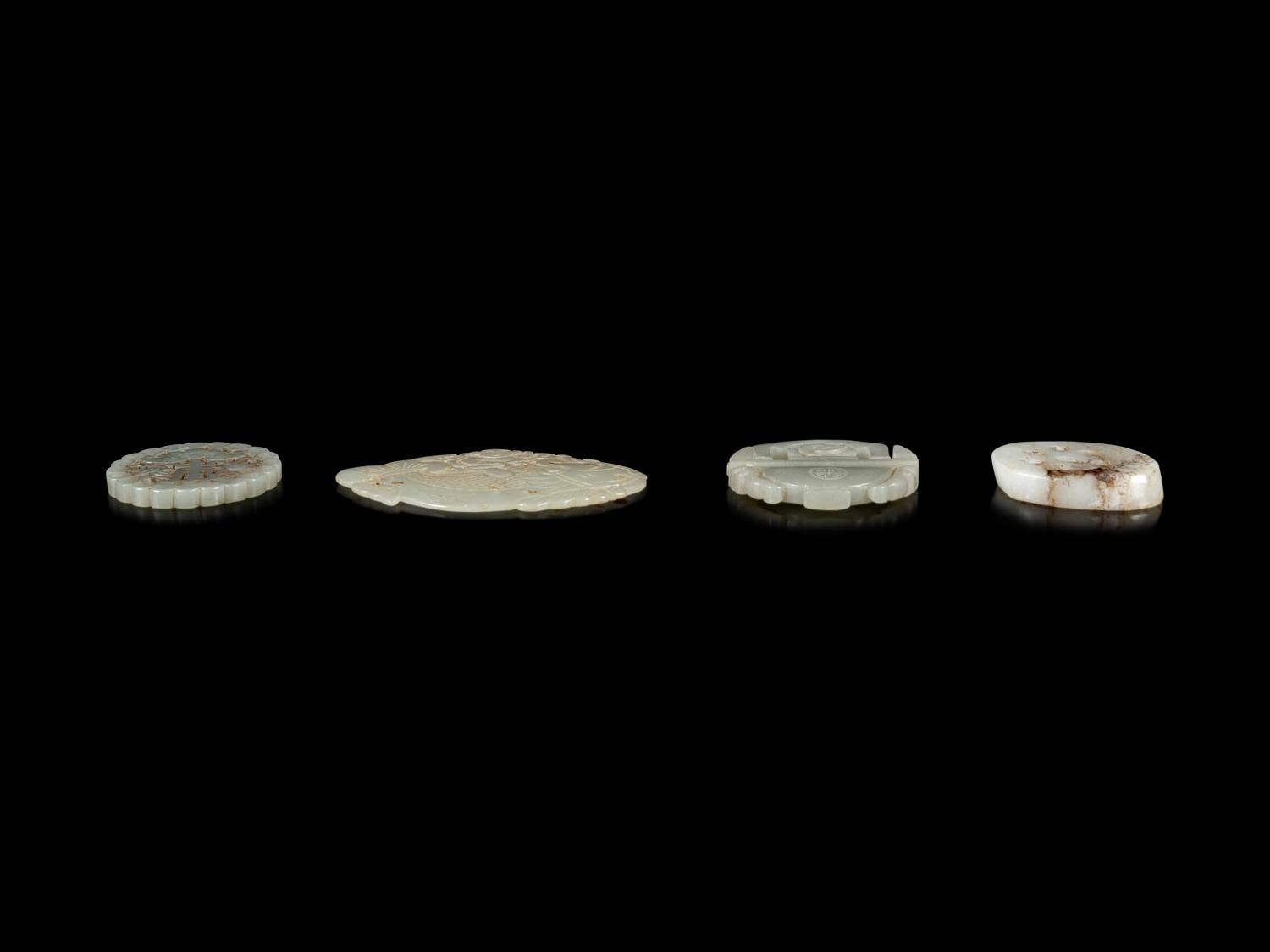 Four Chinese Jade Reticulated Pendants