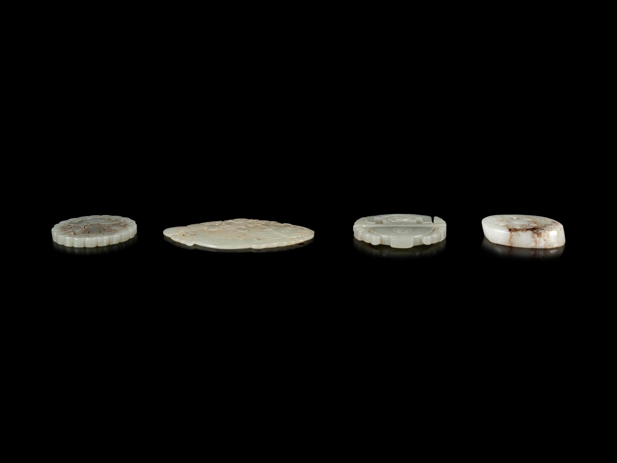 Four Chinese Jade Reticulated Pendants