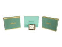 A Tiffany and Co. Travel Clock and Three Sets of Playing Cards