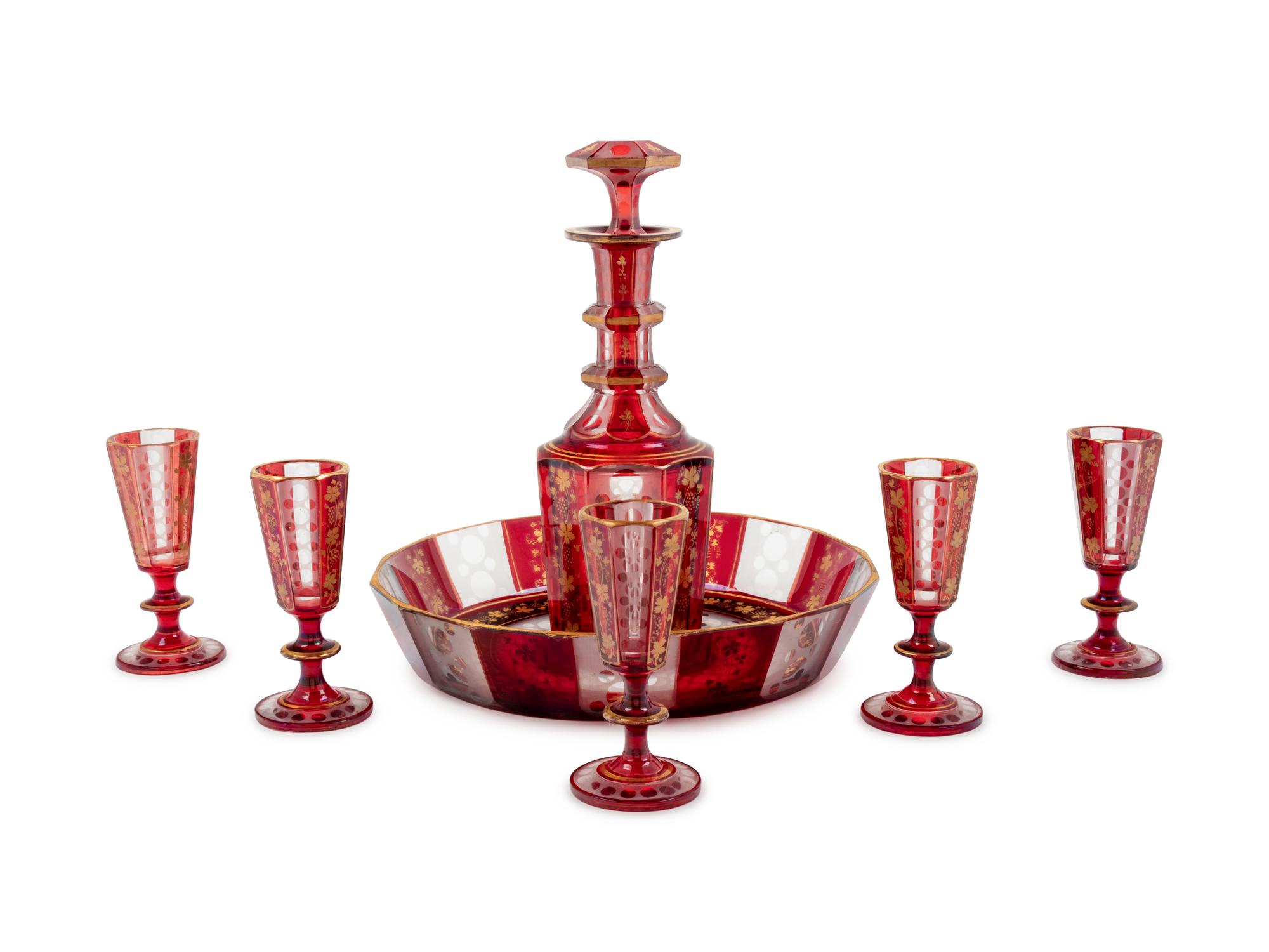 A Bohemian Gilt Decorated Ruby Cut-to-Clear Glass Liquor Set