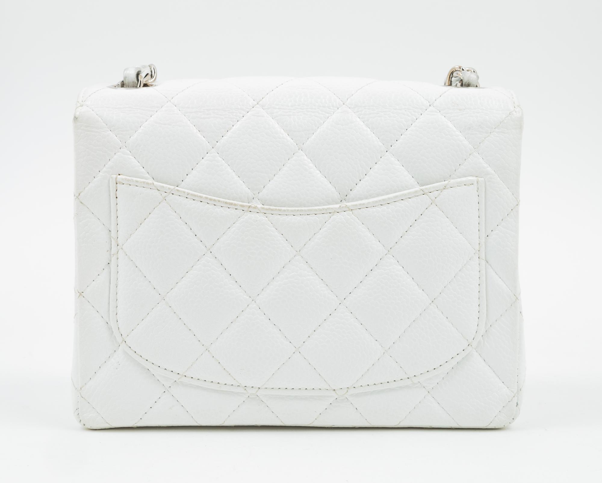 A Chanel White Caviar Mini Cross Body Flap Bag, 6.5" x 5.5" x 2.5"; Strap drop: 21"