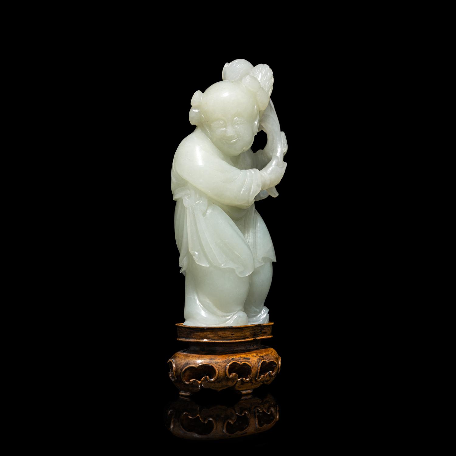 A Chinese Pale Celadon Jade Figure of a Boy, 18th-19th Century 清中期 青白玉 持蓮 童子