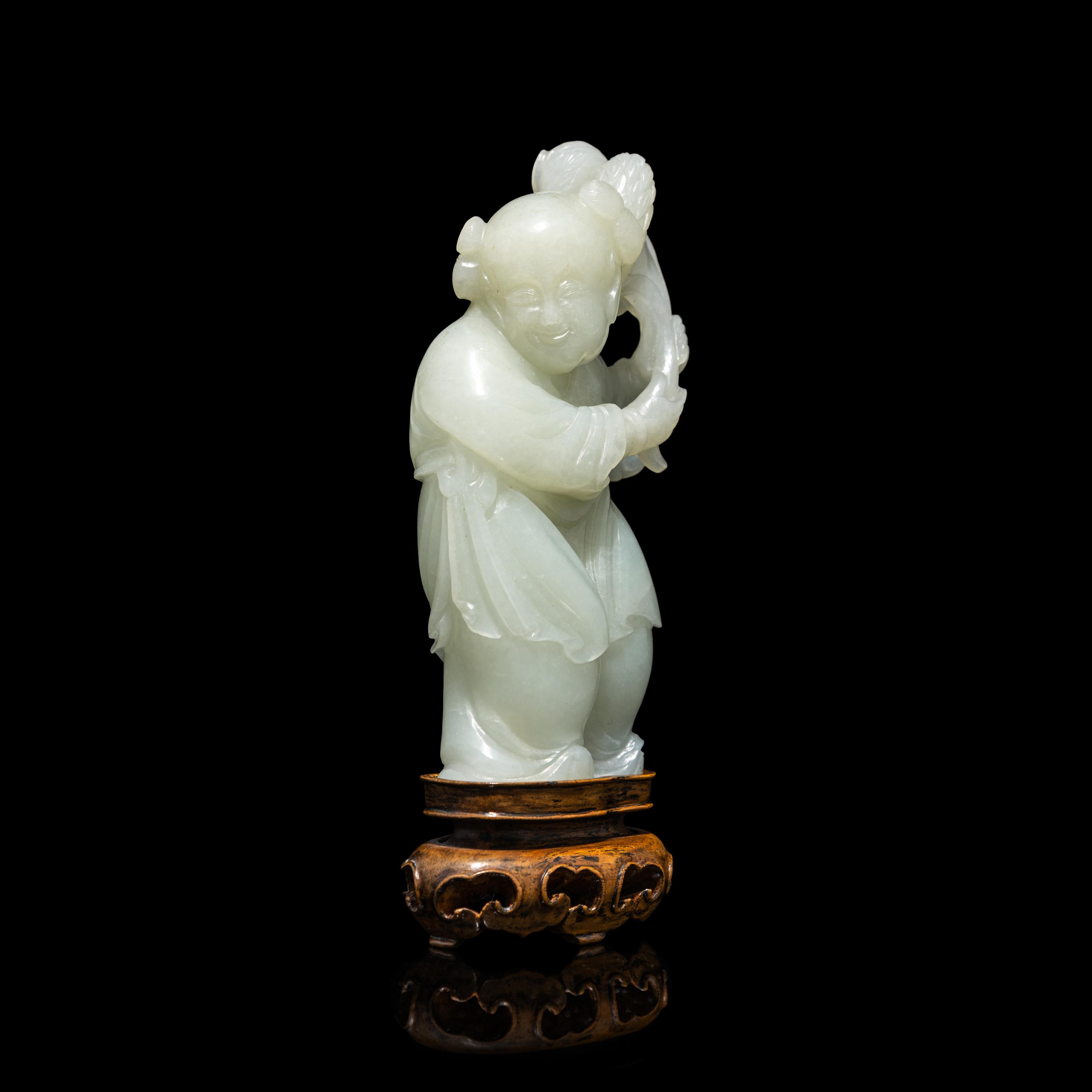 A Chinese Pale Celadon Jade Figure of a Boy, 18th-19th Century 清中期 青白玉 持蓮 童子