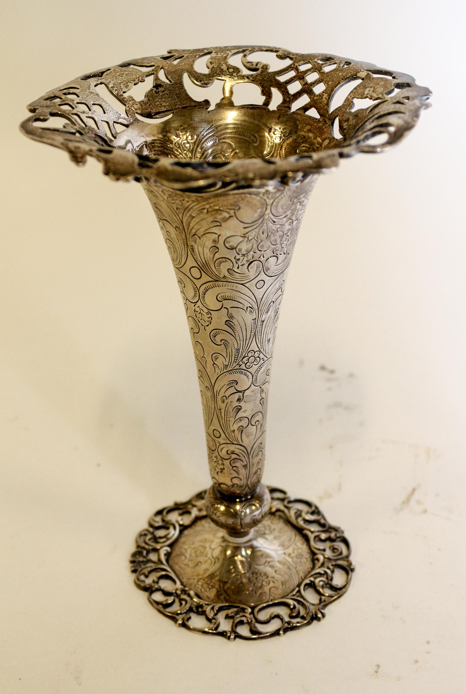 An American Silver Trumpet Vase, J.E. Caldwell & Co., Philadelphia, PA, circular with pierced upper and lower borders, the body chased