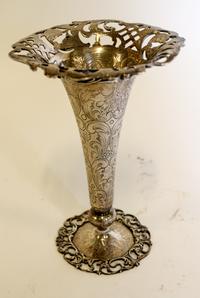 An American Silver Trumpet Vase, J.E. Caldwell & Co., Philadelphia, PA, circular with pierced upper and lower borders, the body chased