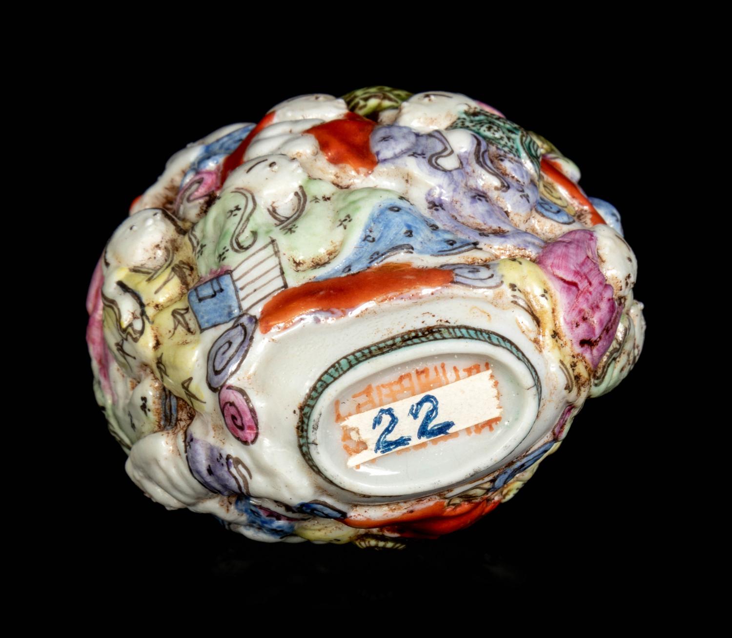 A Chinese Molded Famille Rose Porcelain ‘Luohan’ Snuff Bottle