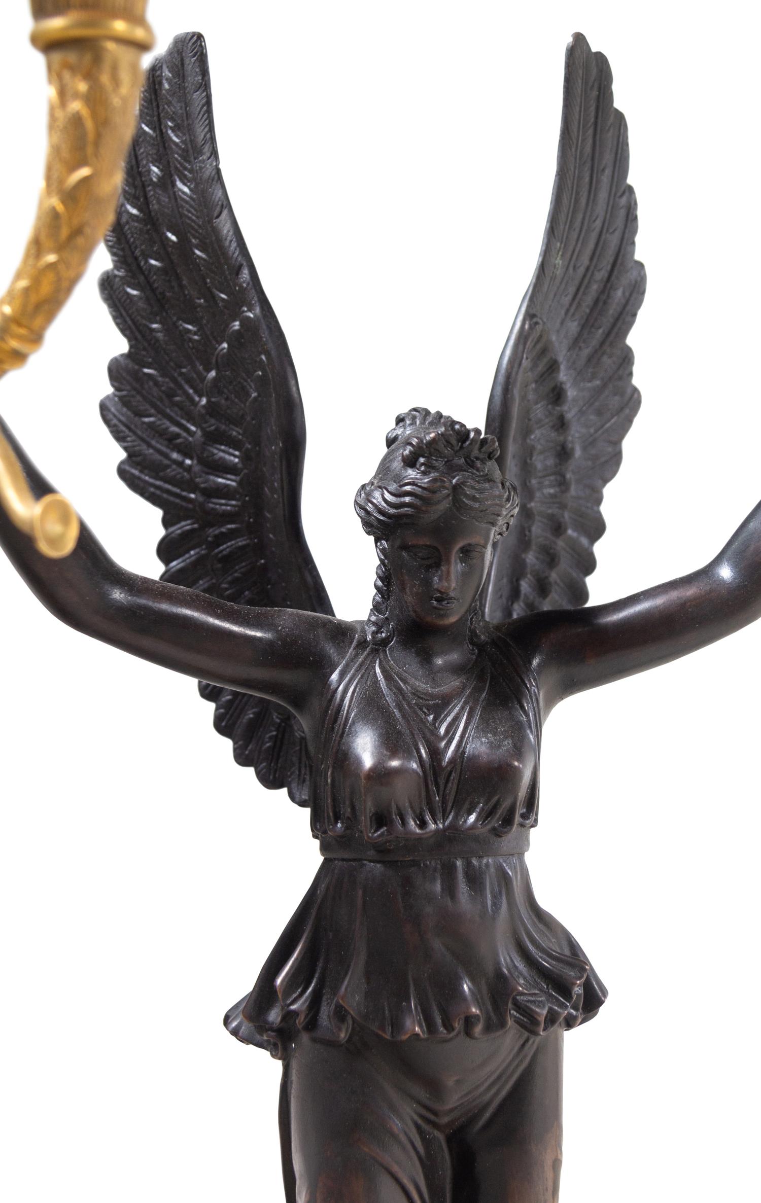 A Pair of Empire Style Gilt and Patinated Bronze Four-Light Candelabra