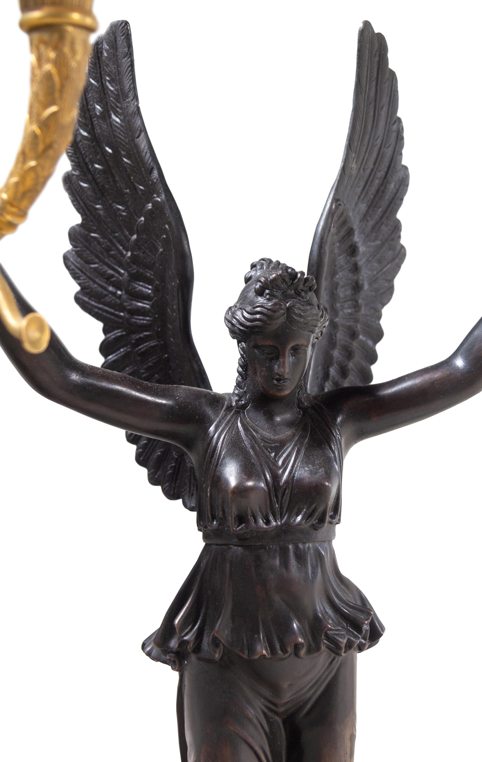 A Pair of Empire Style Gilt and Patinated Bronze Four-Light Candelabra