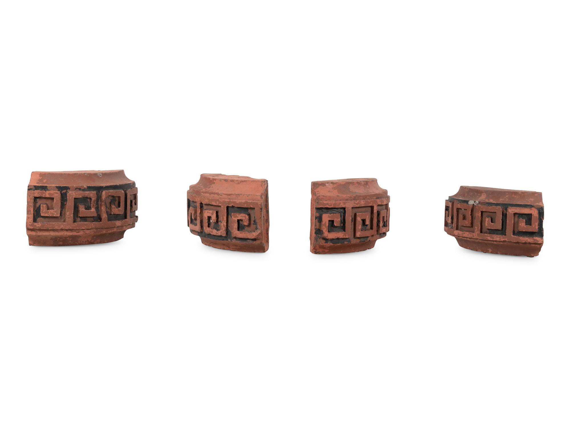 A Set of Four Continental Terra Cotta Ornaments