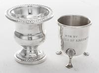 An American Silver Cigarette Urn, , campagna form with gadrooned rims and weighted base, together with another cigarette urn on three s