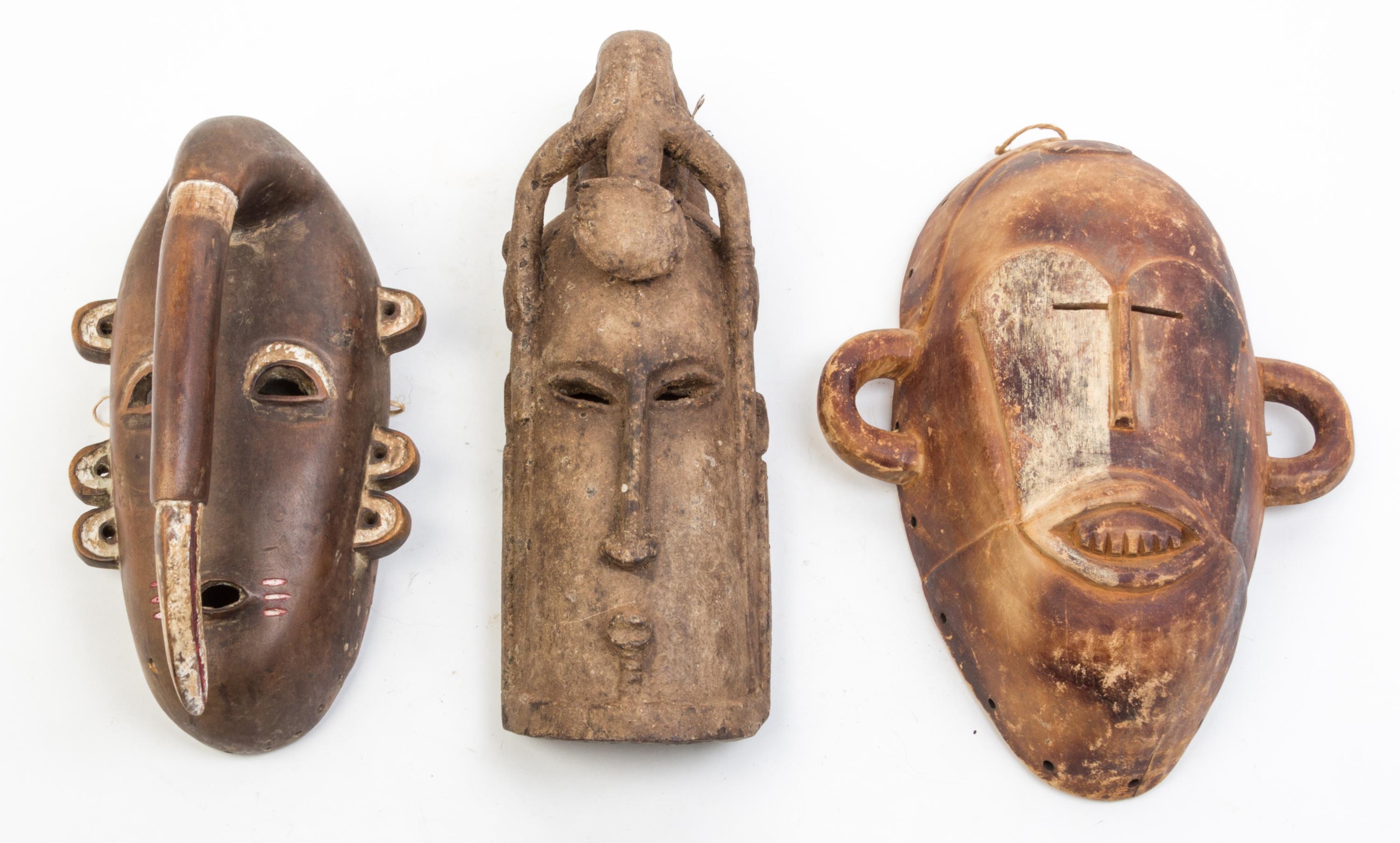 A Group of Four Masks Height of largest 14 1/2 inches.