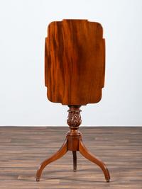 A Late Federal Carved and Figured Mahogany Shaped Top Candlestand