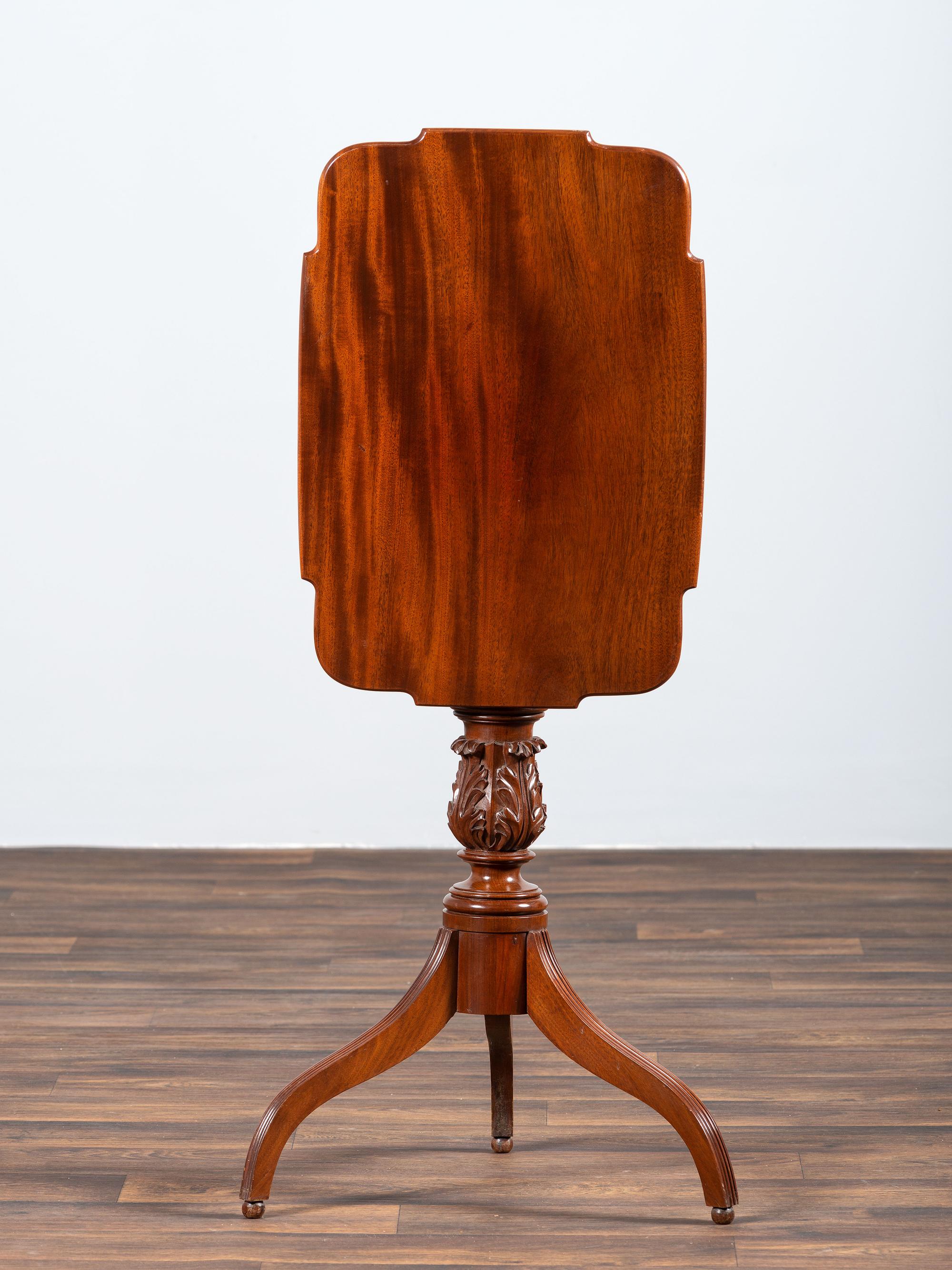 A Late Federal Carved and Figured Mahogany Shaped Top Candlestand