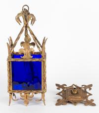 A Glass and Metal Lantern Height 17 1/4 inches.