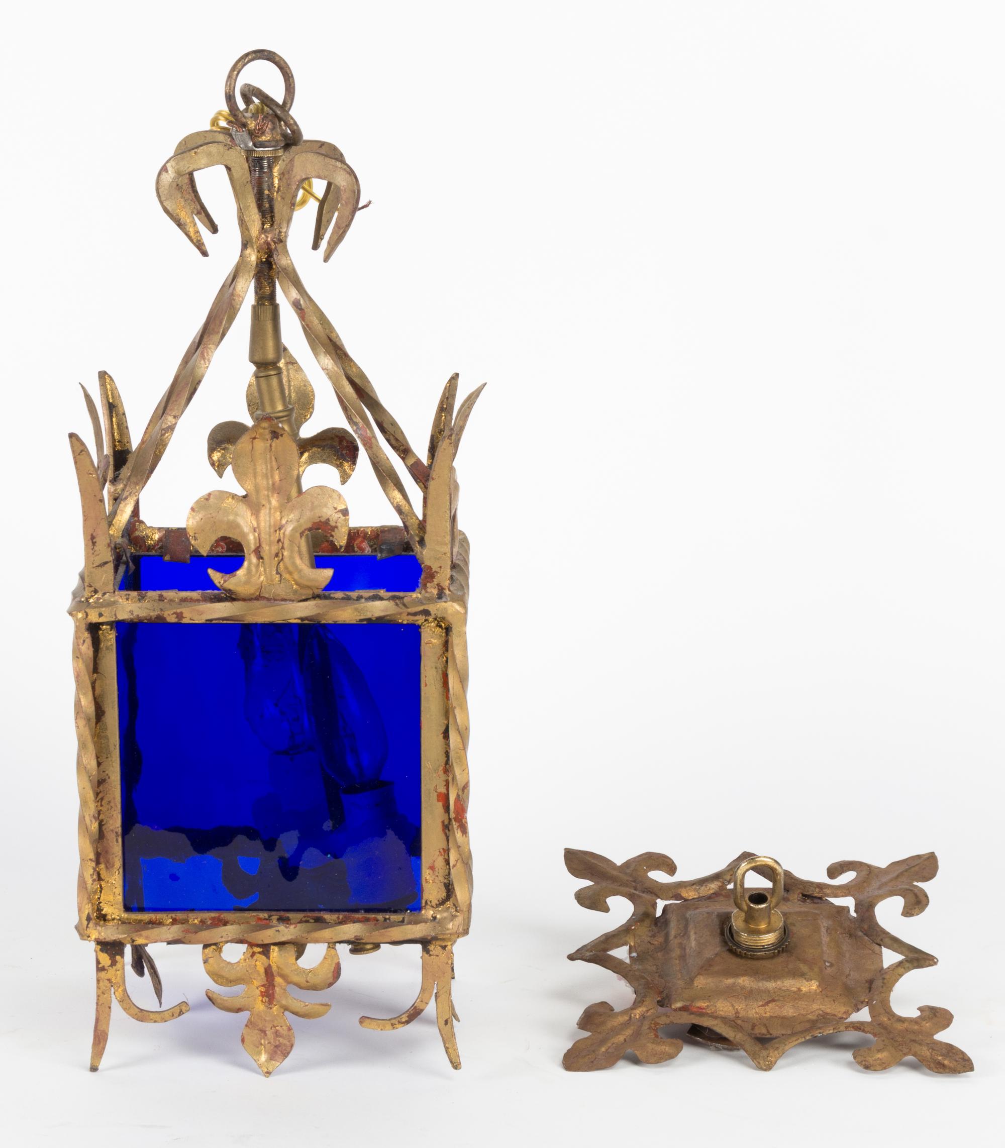 A Glass and Metal Lantern Height 17 1/4 inches.