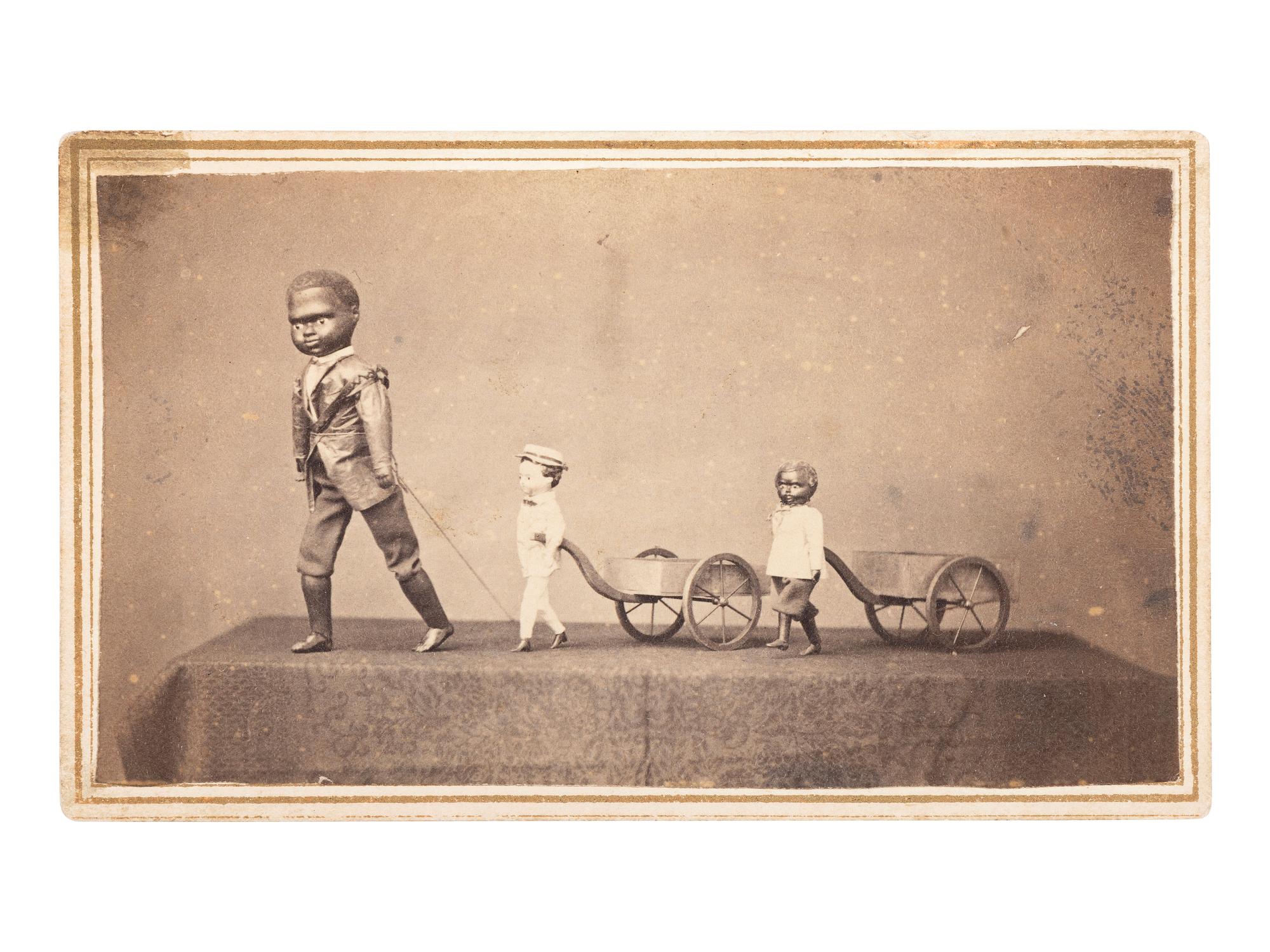 [AFRICAN AMERICANA - EARLY PHOTOGRAPHY]. CDV of a trio of toys displayed on a tabletop.