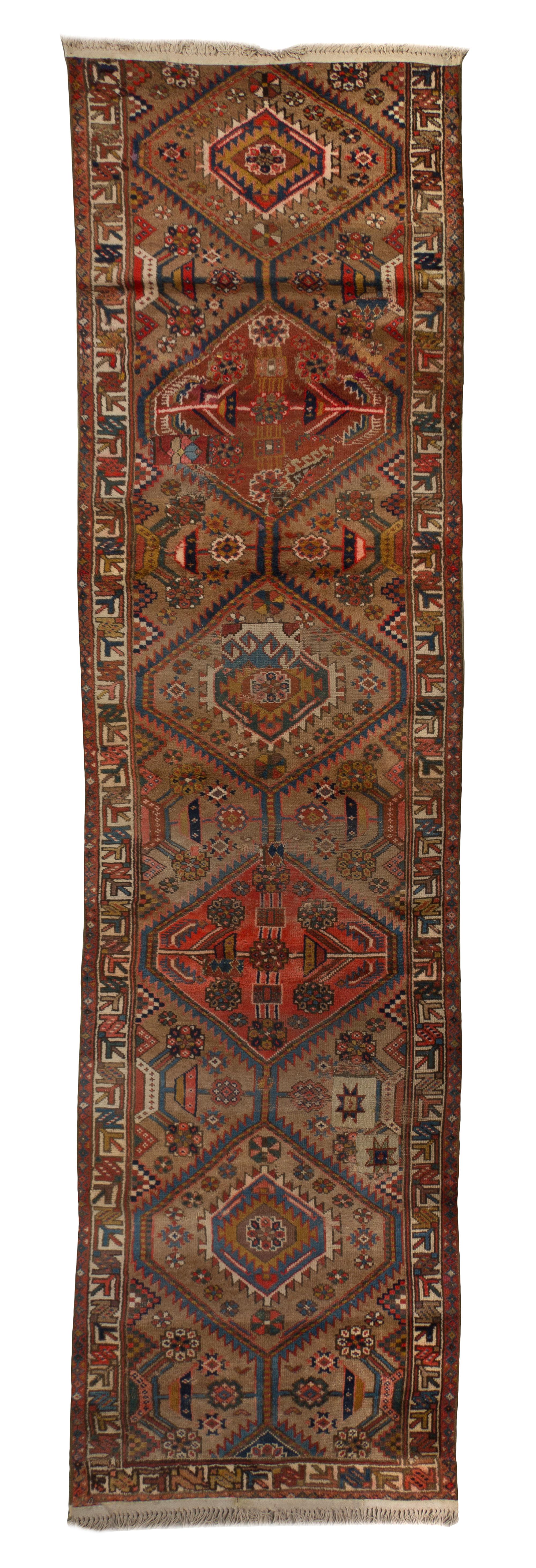A Persian Wool Runner, 11 feet x 2 feet 10 inches.