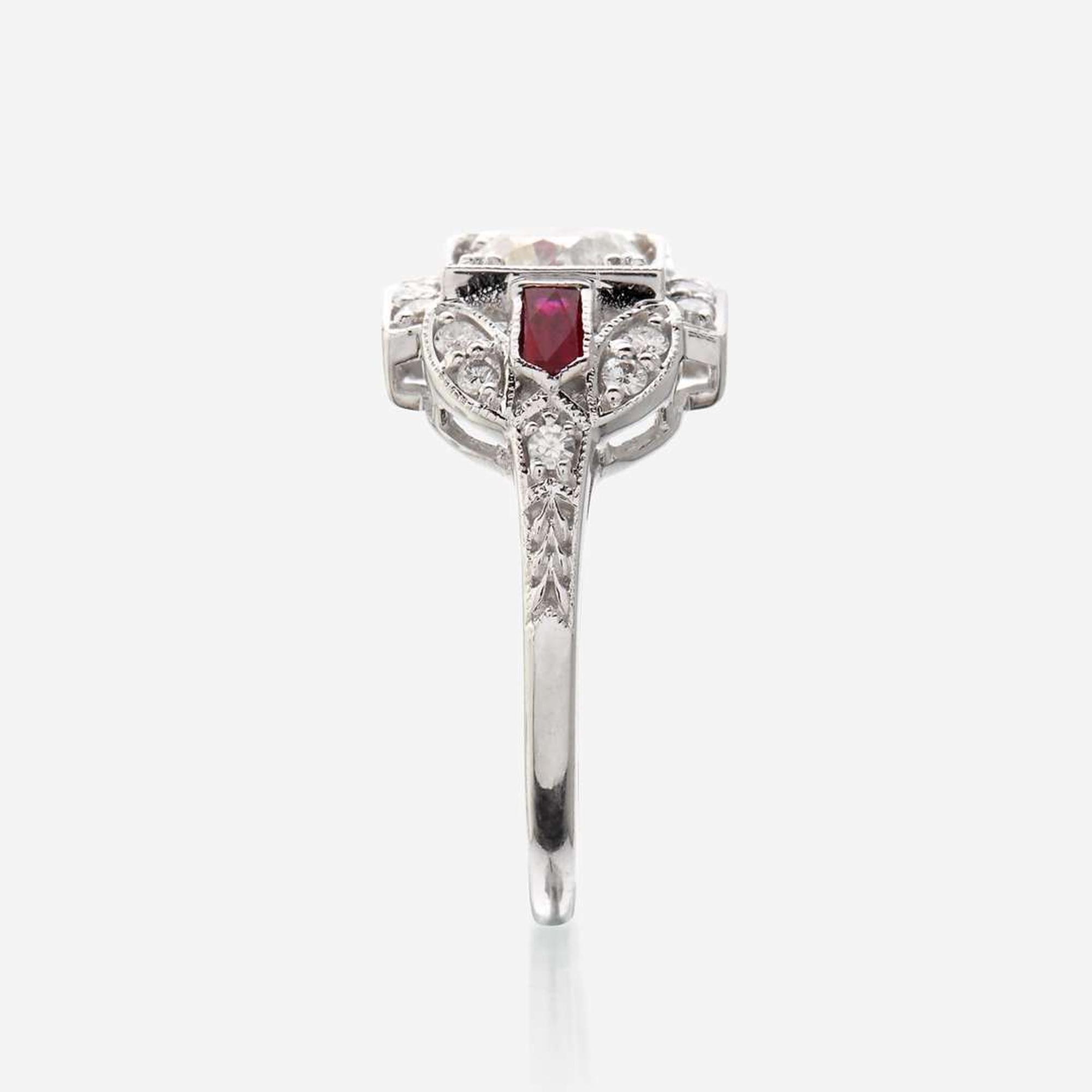 A diamond, ruby, and eighteen karat white gold ring