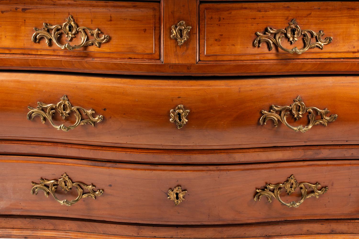 A French Provincial Walnut Bombe Commode