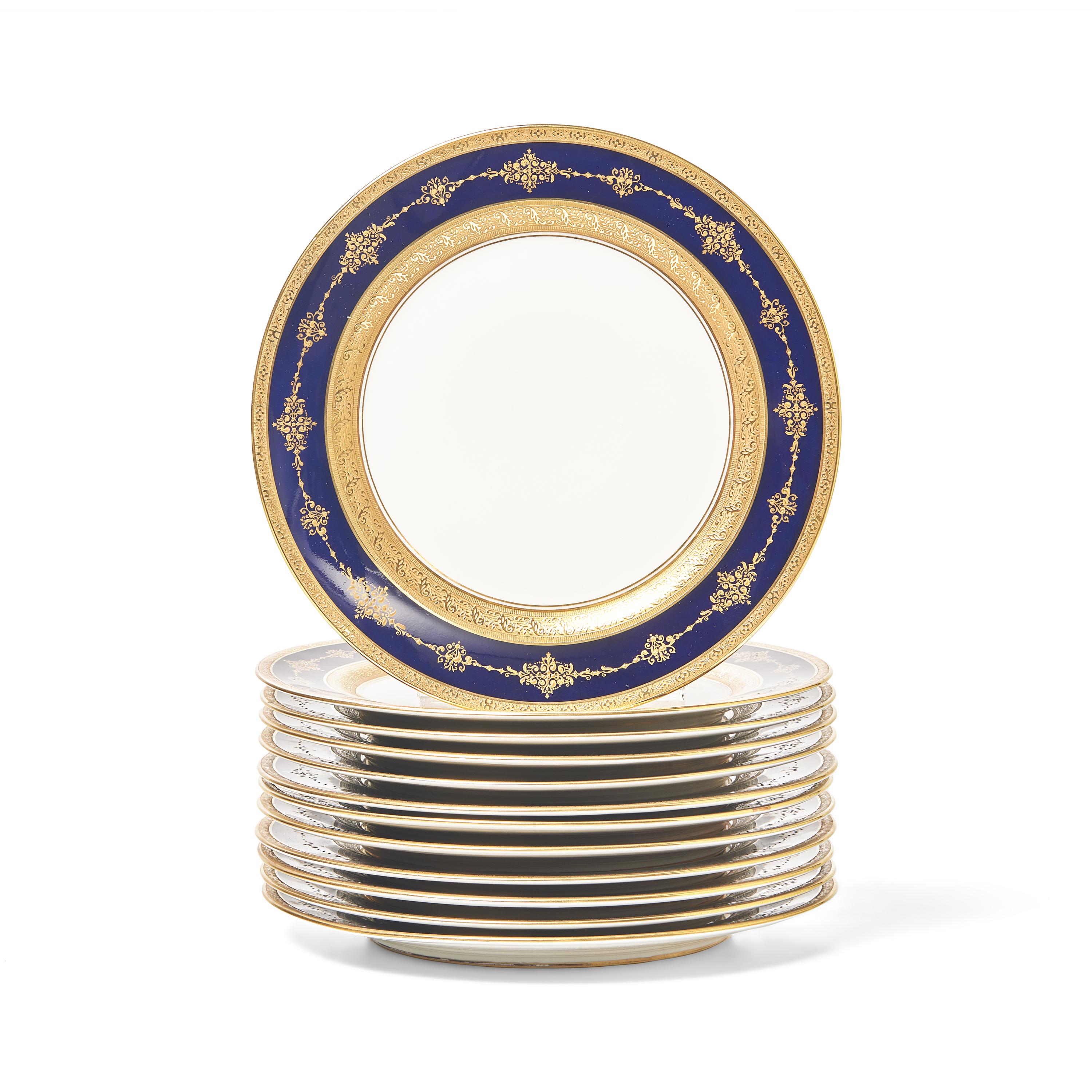 A Set of Twelve Limoges Cobalt Ground Parcel Gilt Dinner Plates