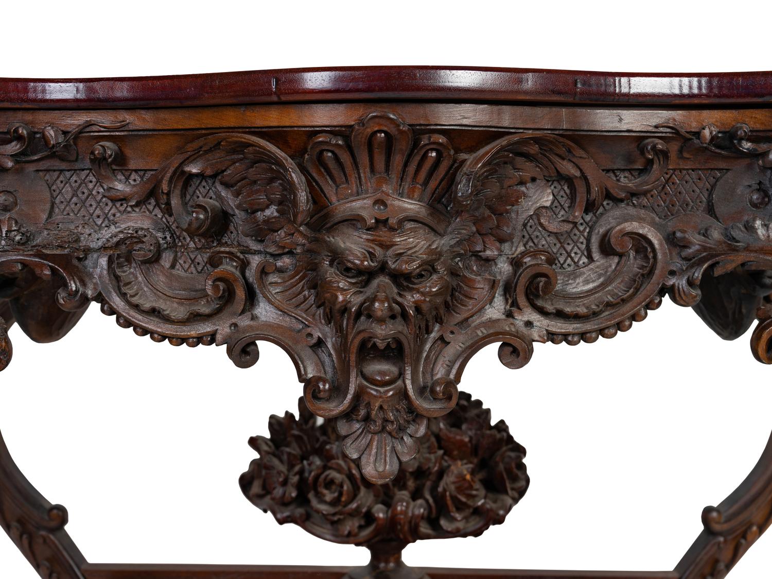 A Renaissance Revival Carved Walnut Serpentine Top Console Table