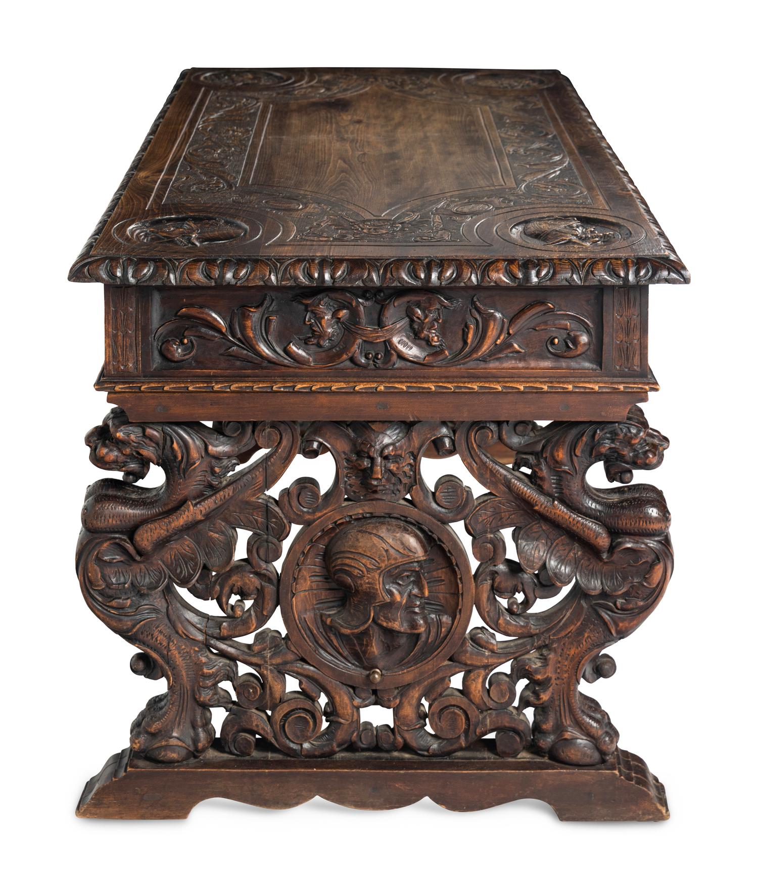 A Renaissance Revival Iron-Mounted Carved Walnut Library Table