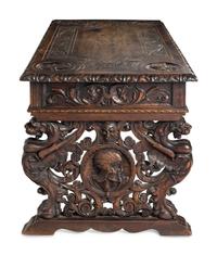A Renaissance Revival Iron-Mounted Carved Walnut Library Table