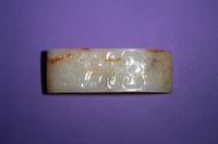 A Chinese White and Russet Jade Sword Slide, Jianzhi