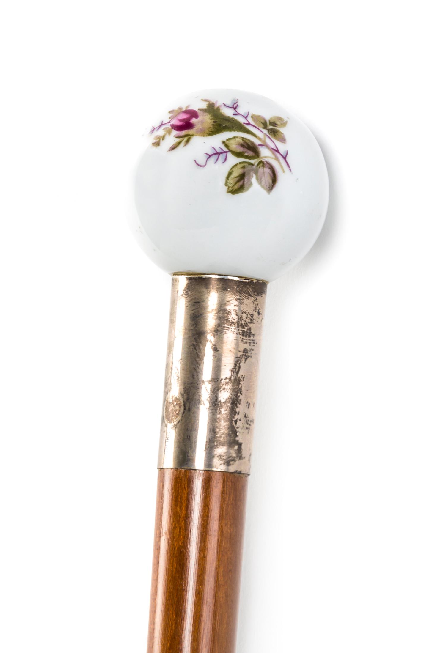 An American Porcelain Handled Walking Stick, Diameter of handle 1 3/4 x length overall 34 3/4 inches.