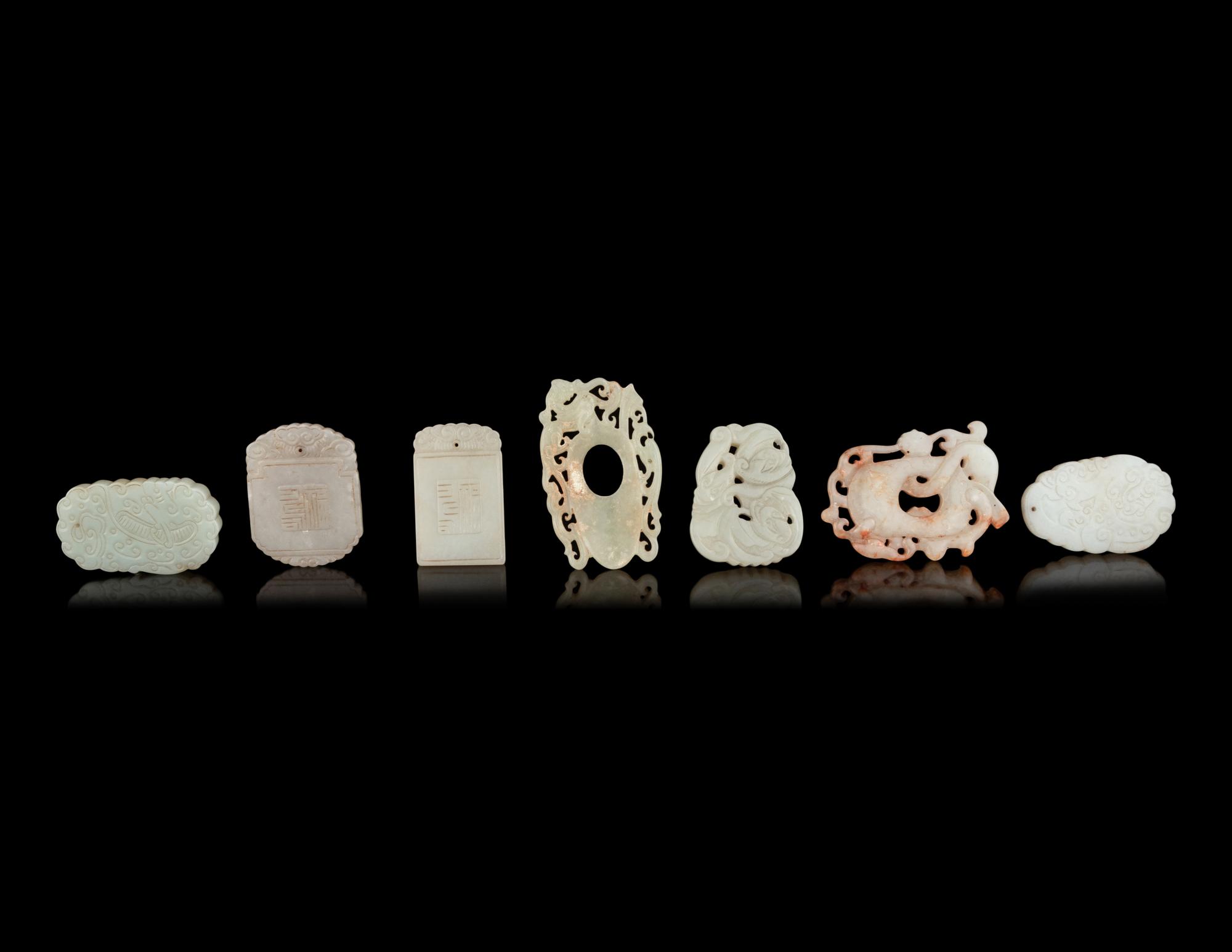 Seven Chinese Carved Celadon Jade Pendants