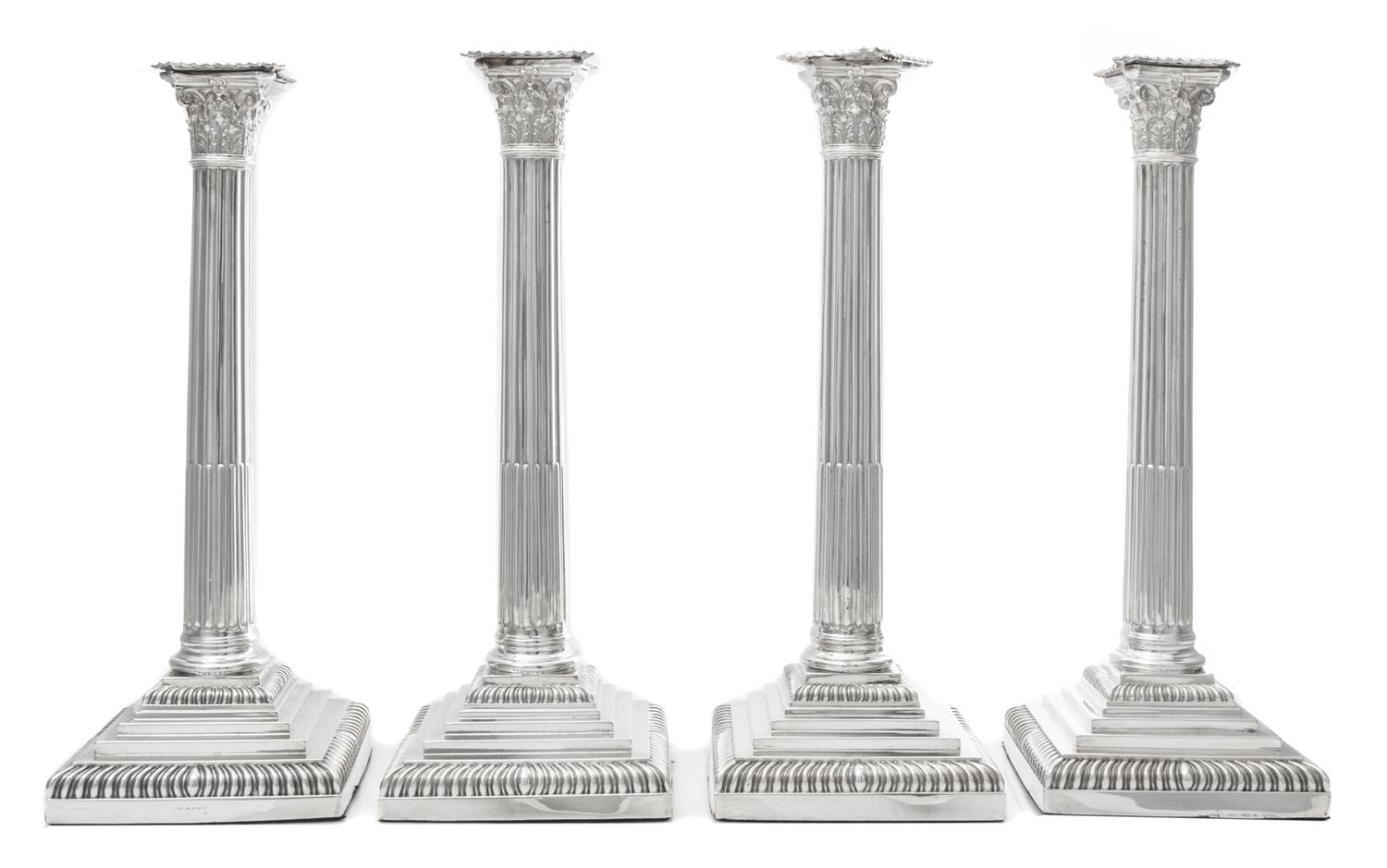 A Set of Four English Silver-Plate Candlesticks, Maker's mark obscured, each of Corinthian columnar form, raised on a stepped base with