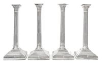 A Set of Four English Silver-Plate Candlesticks, Maker's mark obscured, each of Corinthian columnar form, raised on a stepped base with