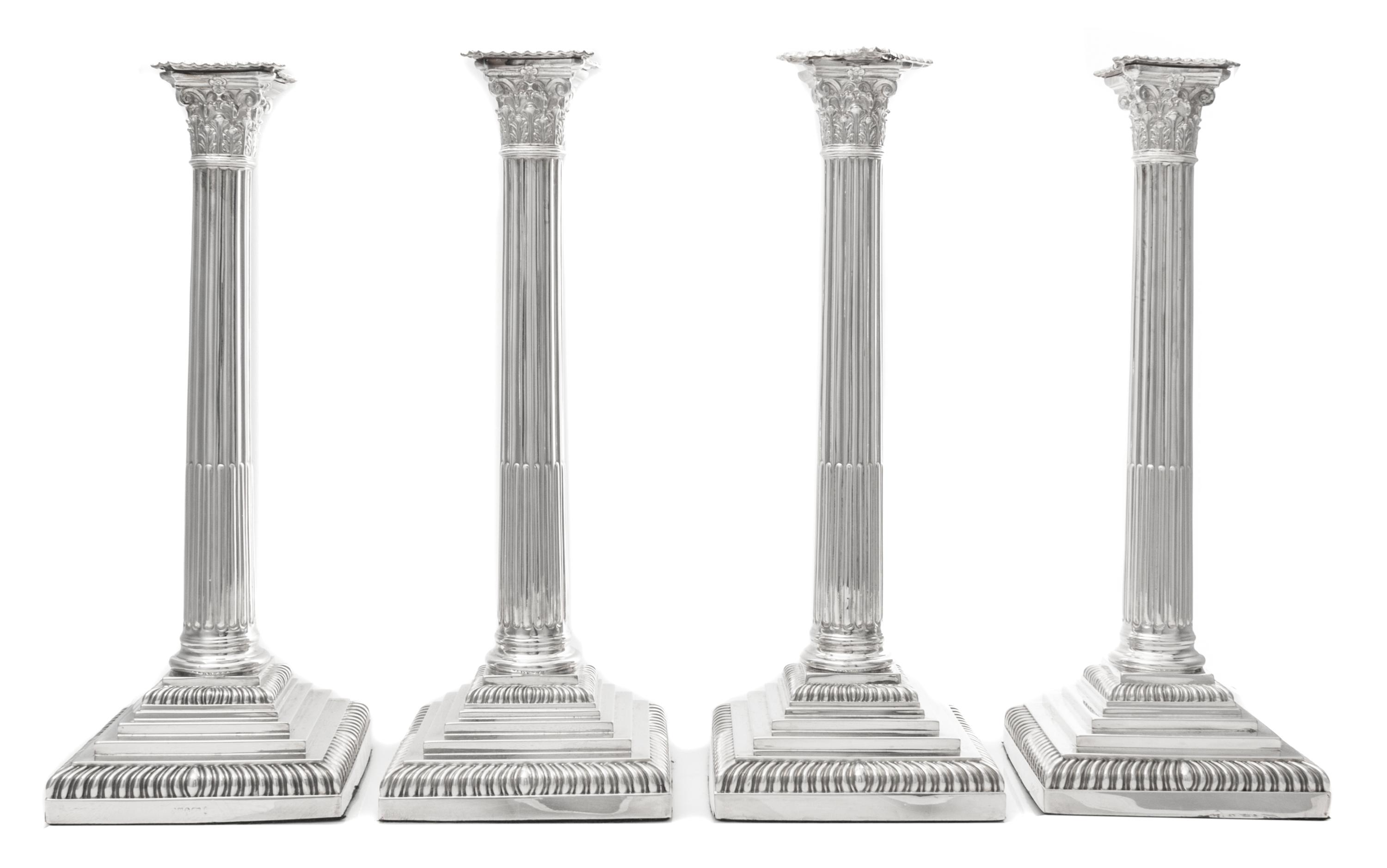 A Set of Four English Silver-Plate Candlesticks, Maker's mark obscured, each of Corinthian columnar form, raised on a stepped base with