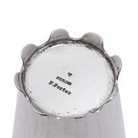 An Arts and Crafts Sterling Silver Tea Strainer and Stand