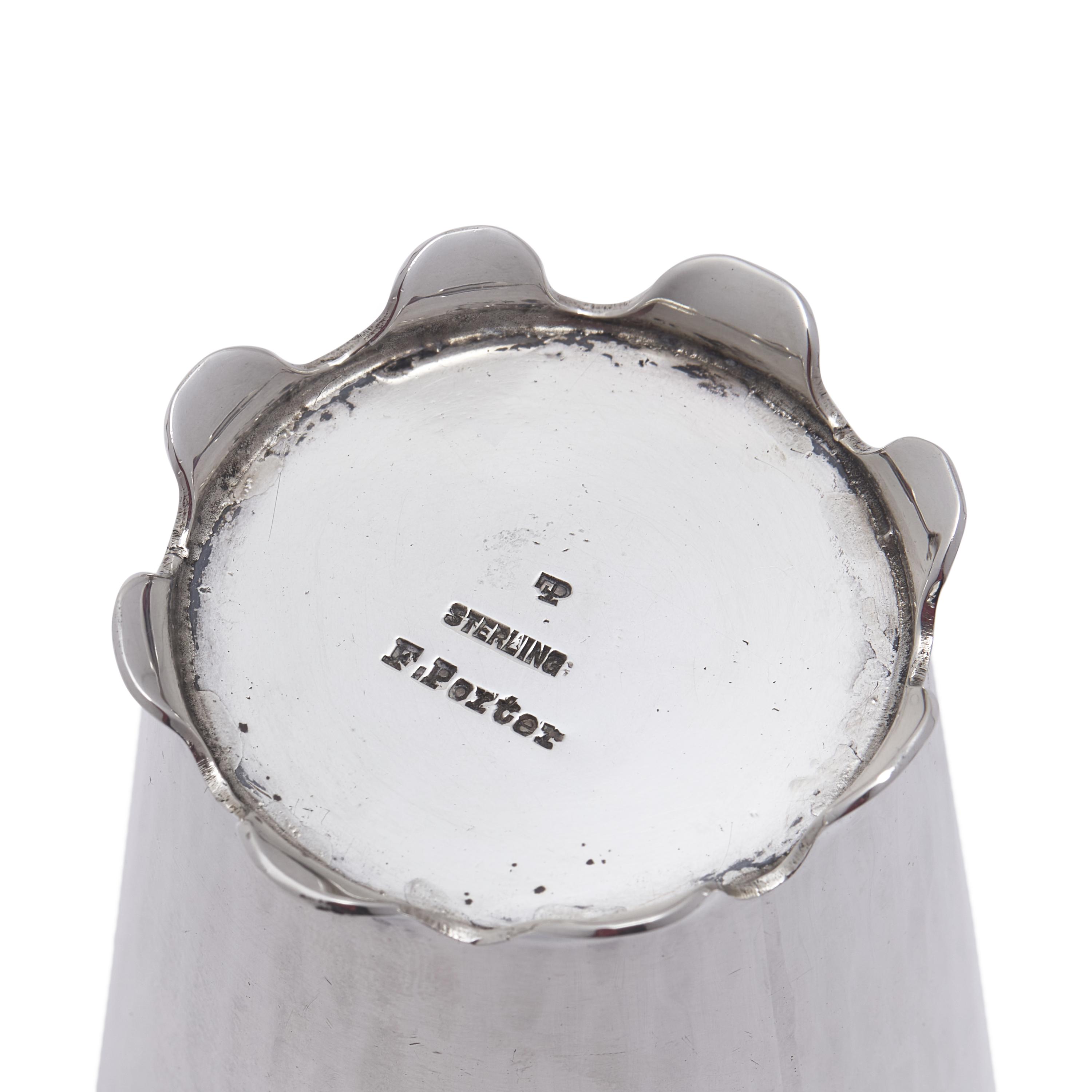 An Arts and Crafts Sterling Silver Tea Strainer and Stand
