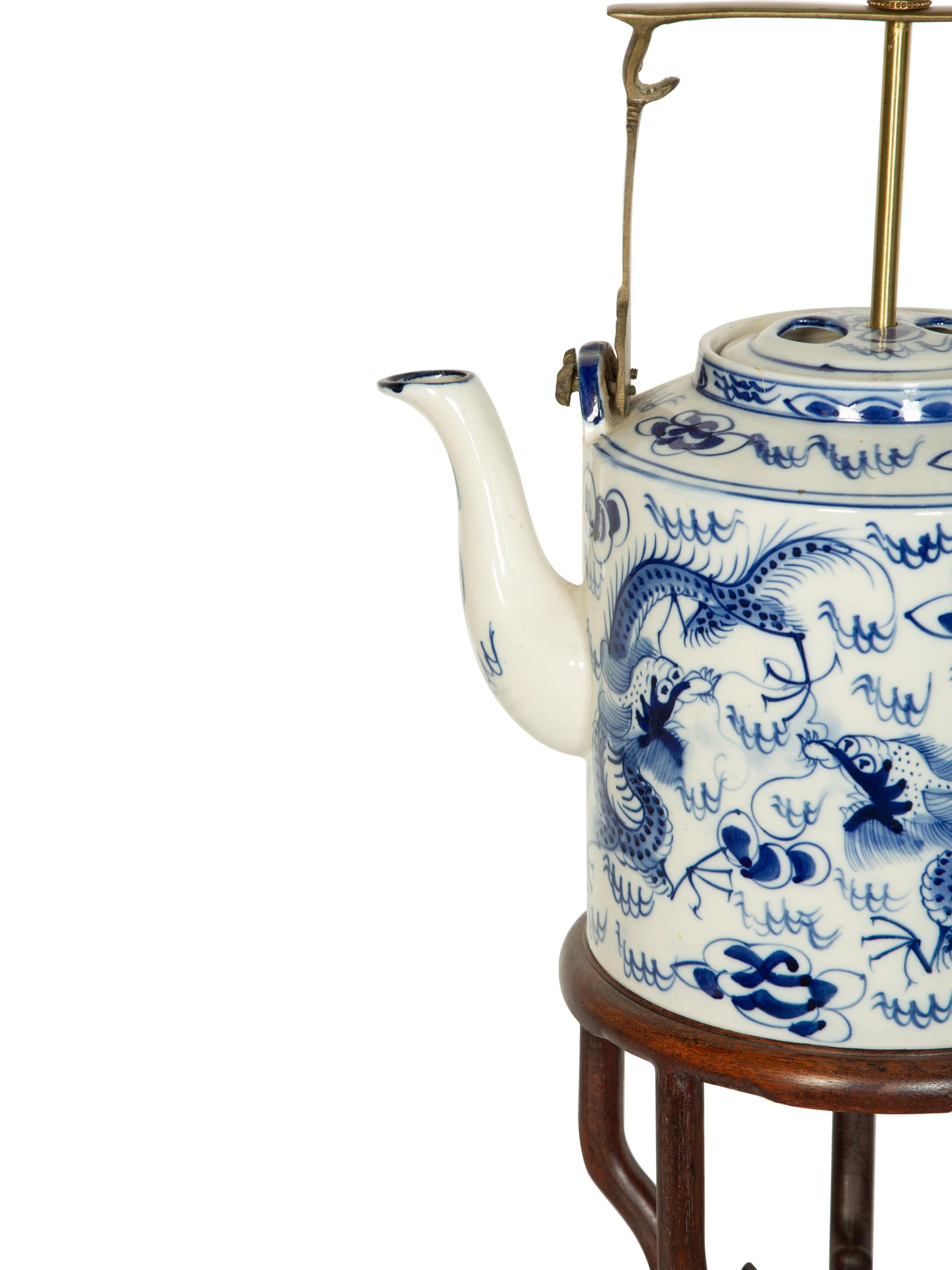 An Oversized Chinese Export Porcelain Teapot Mounted as a Lamp with a Wood Stand