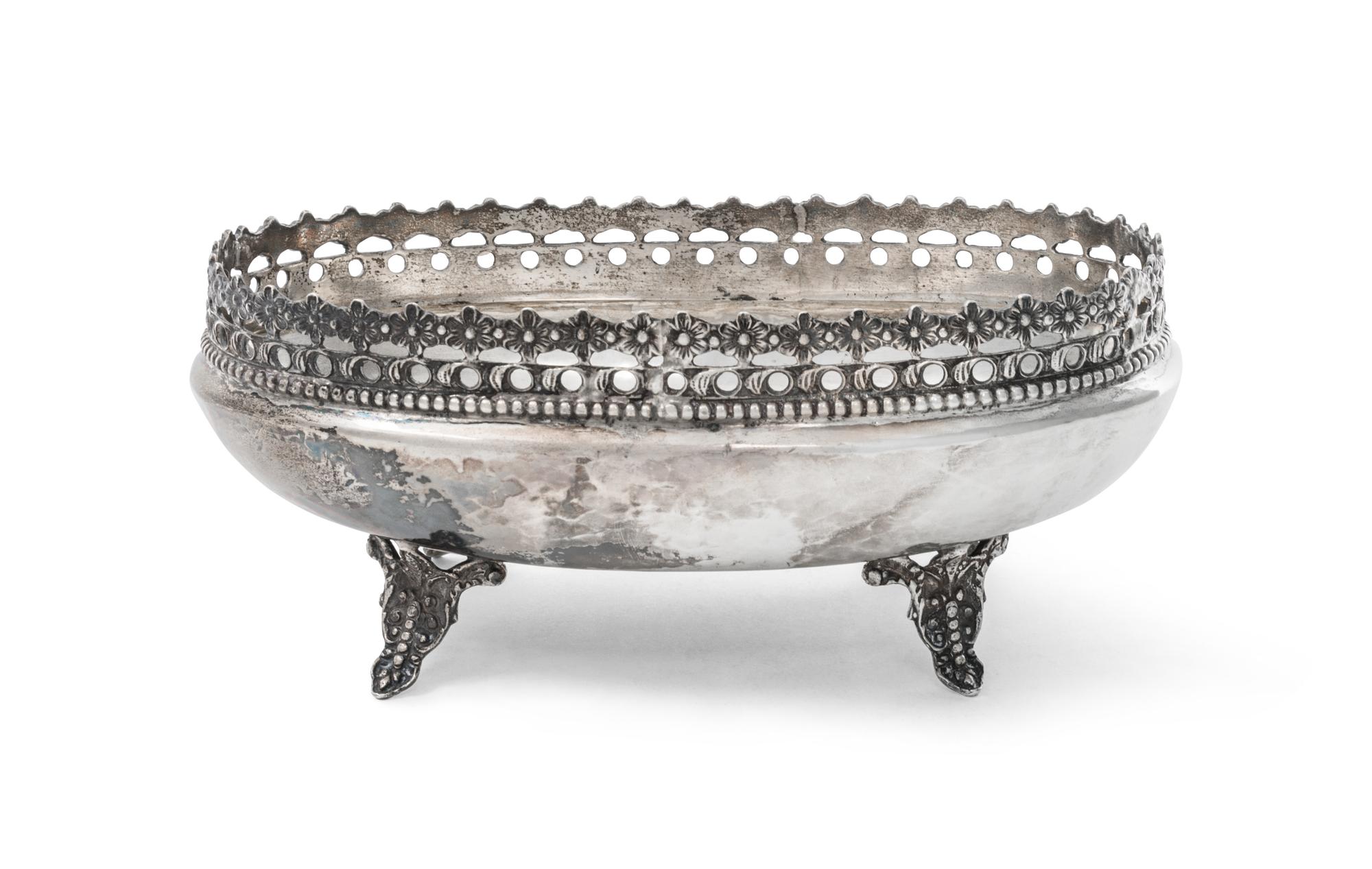A Continental Silver Cake Basket, , of oval form with a pierced floral decorated rim and raised on foliate feet.