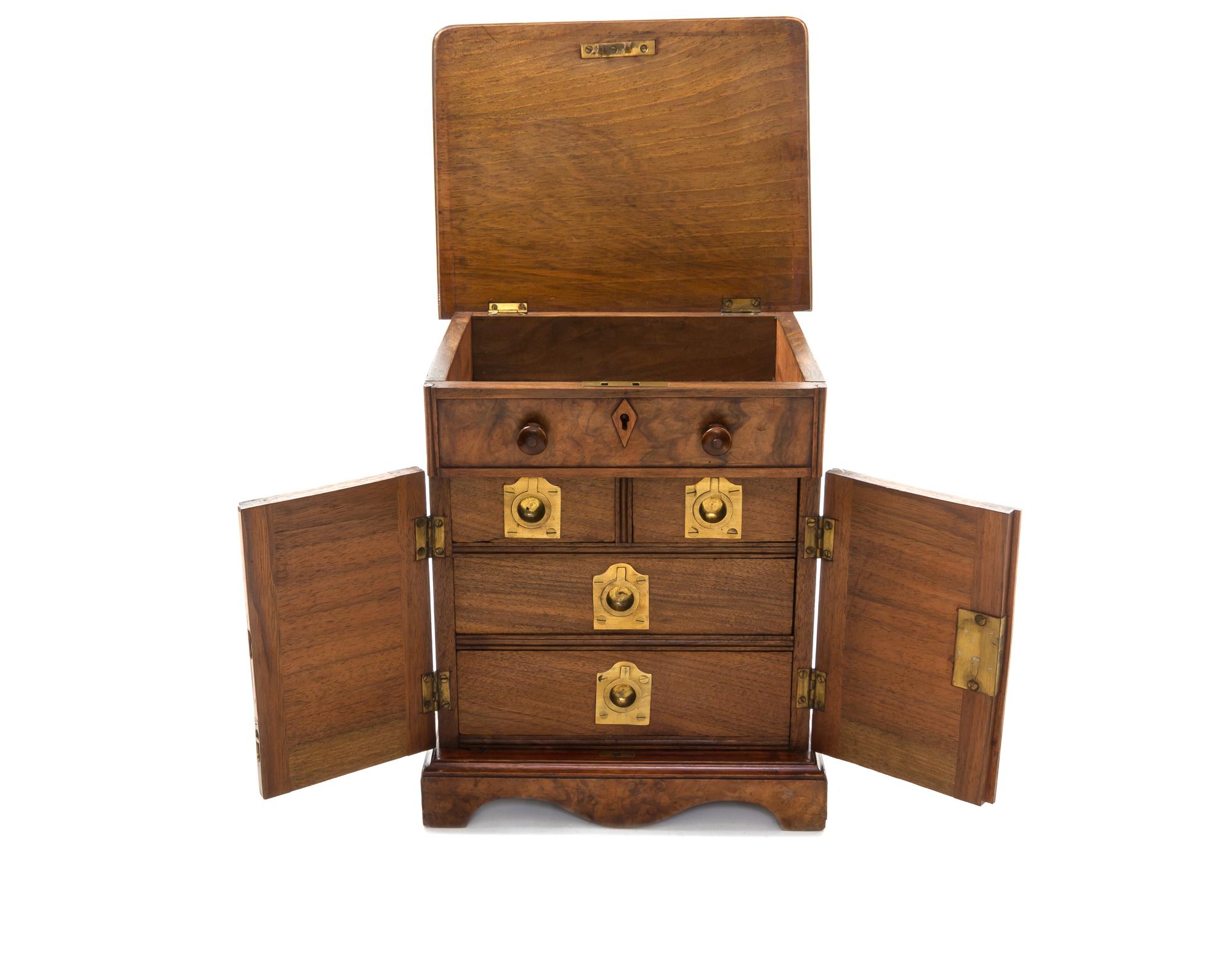 A Burl Walnut and Teak Campaign Jewelry Chest, Height 11 5/8 x width 7 3/4 x depth 10 inches.