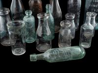 Sixteen Glass Advertising Bottles