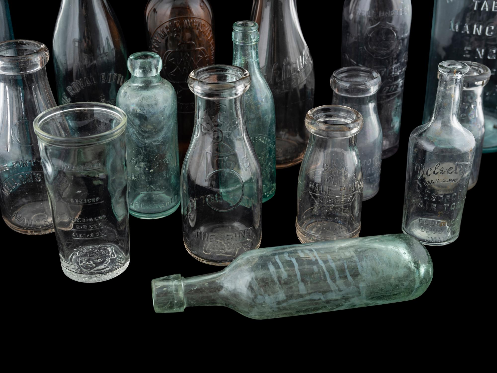 Sixteen Glass Advertising Bottles