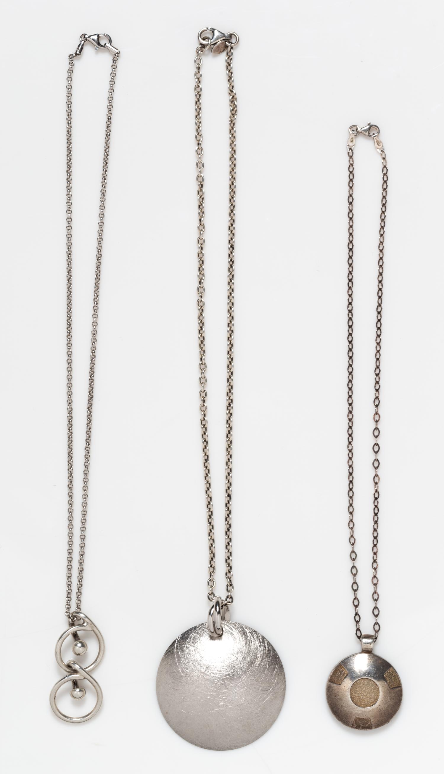 A Collection of Sterling Silver Circular Motif Pendant Necklaces, 34.60 dwts.